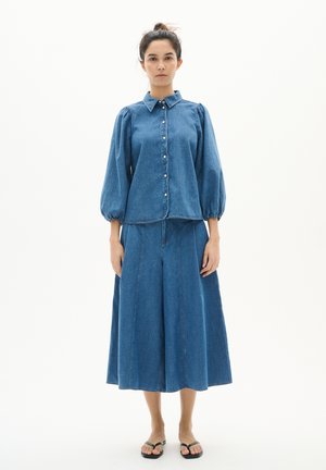Denim shirt and skirt set, blue, with puffed sleeves, button front, and a wide skirt silhouette, made of soft textured fabric.