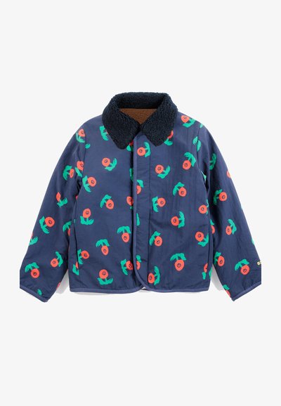 Veste bleu marine avec col en polaire noire, décorée de motifs floraux circulaires verts et orange, manches longues et fermeture à boutons devant.