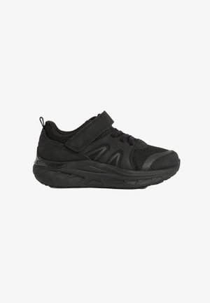 Black athletic shoes with a Velcro strap, mesh and synthetic upper, textured rubber sole, and reinforced toe cap. Lightweight design.