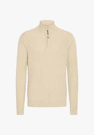 Beež villane sviiter kõrge kaeluse ja veerand-zipp disainiga. Omab soonikuid mansette ja hemmi, tekstuurset kangast ning minimaalset detailide kasutust.