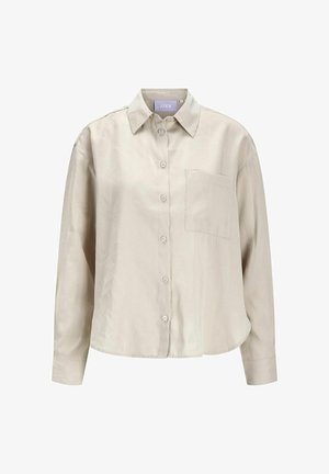 Camicia button-up beige chiaro realizzata in tessuto morbido, con colletto, maniche lunghe, una tasca sul petto e orlo arrotondato.