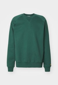 Groene sweatshirt met een ronde hals, lange mouwen en geribbelde manchetten. Heeft een driehoekig stiksel detail en een logo op de zoom.