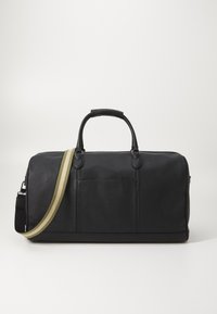 Black leather duffel bag with a textured surface, dual handles, and an adjustable striped shoulder strap. Features a front pocket.