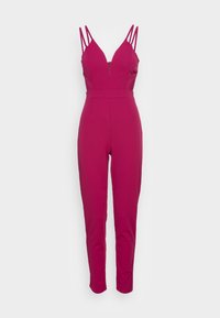 Salopette fucsia con profonda scollatura a V, spalline sottili doppie, gambe affusolate e chiusura lampo sul davanti. Tessuto di consistenza liscia.