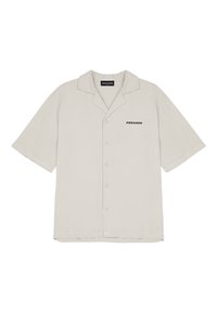 Licht beige korte mouw blouse met knopen en kraag, met "PEGADOR" tekstlogo op de linkerborst.