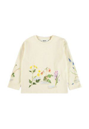 Camisa de manga larga en color crema con estampados florales y etiquetas. Material de algodón suave, ajuste relajado, cuello redondo, colores vibrantes de amarillo, rosa y azul.