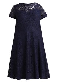 Navy blue lace dress with short sleeves, featuring floral patterns and a skater silhouette. The fabric has a textured, intricate design.