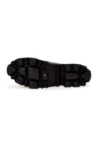 Semelle de botte noire en caoutchouc robuste avec des rainures profondes et une étiquette de taille "37" visible au centre.