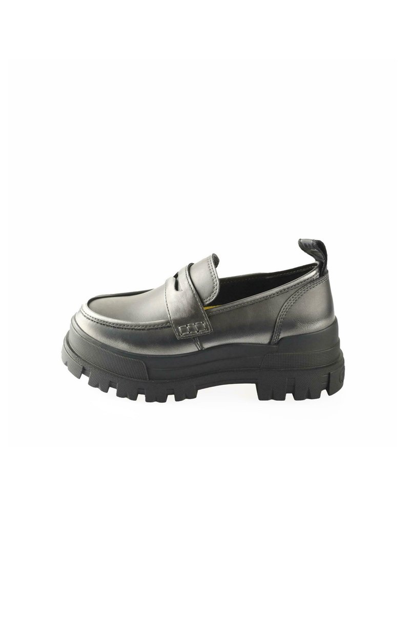 Black leather slip-on shoe with a rounded toe, featuring a thick textured rubber sole and a raisedback heel tab for easy wear.