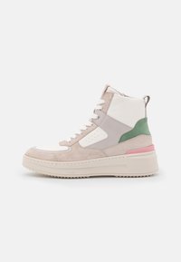High-top sneakers featuring a mix of beige, white, and green suede, with a textured sole and pink accent on the heel.