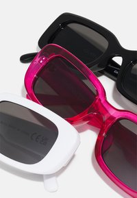 Three pairs of sunglasses: black, pink transparent, and white. All feature square frames with dark lenses. Lens shapes and textures vary slightly.