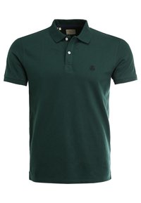 Polo noir en coton. Il présente un col classique, une patte de boutonnage à trois boutons et un logo brodé discret sur la poitrine.