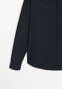 Camicia a maniche lunghe blu navy realizzata in tessuto testurizzato, con chiusura a bottoni, polsini robusti e orlo curvo.
