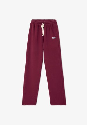 Bordo spalvos sportiniai kelnes su laisvu kirpimu, pagamintos iš minkštos medžiagos. Turi elastingą liemenį su raišteliu ir mažą logotipą priekyje.