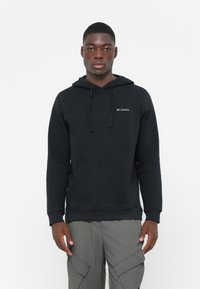 Felpa con cappuccio nera in misto cotone, dotata di tasca frontale e logo Columbia sul petto. Tessuto liscio, vestibilità comoda.