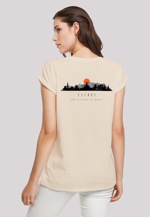 Beige t-shirt featuring a black silhouette design of mountains and buildings, with a red sun above and "ESCAPE" text underneath.