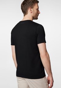 Czarny krótki rękaw T-shirt z gładkiej bawełny, z okrągłym dekoltem i subtelnym logo na górnej części pleców.