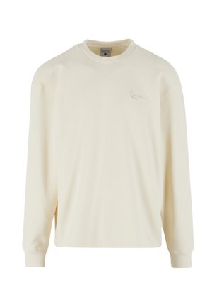 Langärmliges Shirt in Cremefarbe mit strukturierter Waffeloptik, geripptem Ausschnitt und Bündchen, versehen mit einem dezenten Logo auf der Vorderseite.