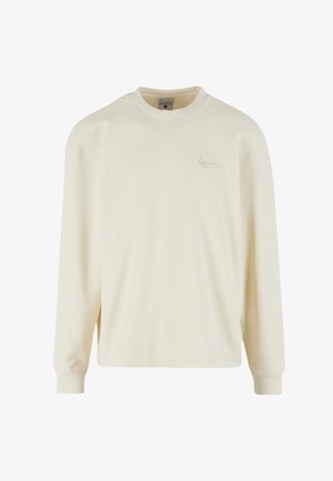 Cămașă cu mânecă lungă, culoare crem, cu model texturat tip vafe, guler și manșete rebițe, având un logo subtil pe față.