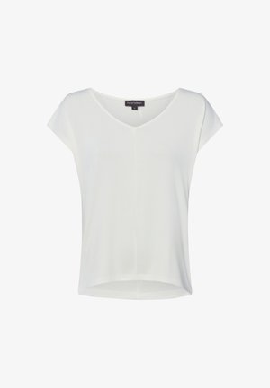 Haut blanc pour femme à manches courtes et col en V, avec un ourlet légèrement incurvé et une couture centrale à l'avant.