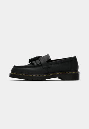 Schwarzer Lederloafer mit Quasten, gelben Nähten entlang der Sohle und einer dicken, gerippten Gummisohle.
