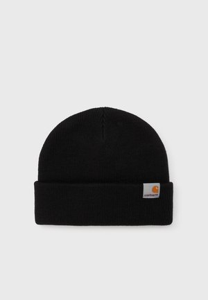 Gorro de malha preta com dobra na parte superior. Feito de um tecido macio, apresenta uma pequena etiqueta com o logótipo da Carhartt em laranja e branco na lateral.