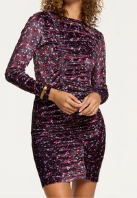 Robe en velours à manches longues, design froncé de couleur violet foncé avec des motifs floraux multicolores et des pois, style ajusté avec une longueur mini.