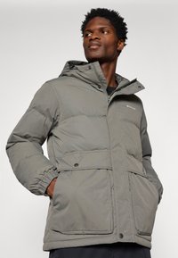 Gray insulated jacket featuring a hood, zip front, elastic cuffs, and two front pockets. Smooth texture with stitched panel design.