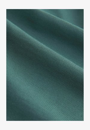 Textured fabric in dark teal, featuring a smooth finish with a subtle ribbed pattern and slight sheen, showcasing its softness and depth.