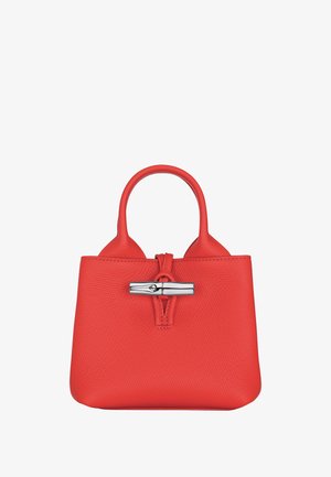 Red textured leather handbag with rounded handles and a silver horizontal clasp closure at the front center.