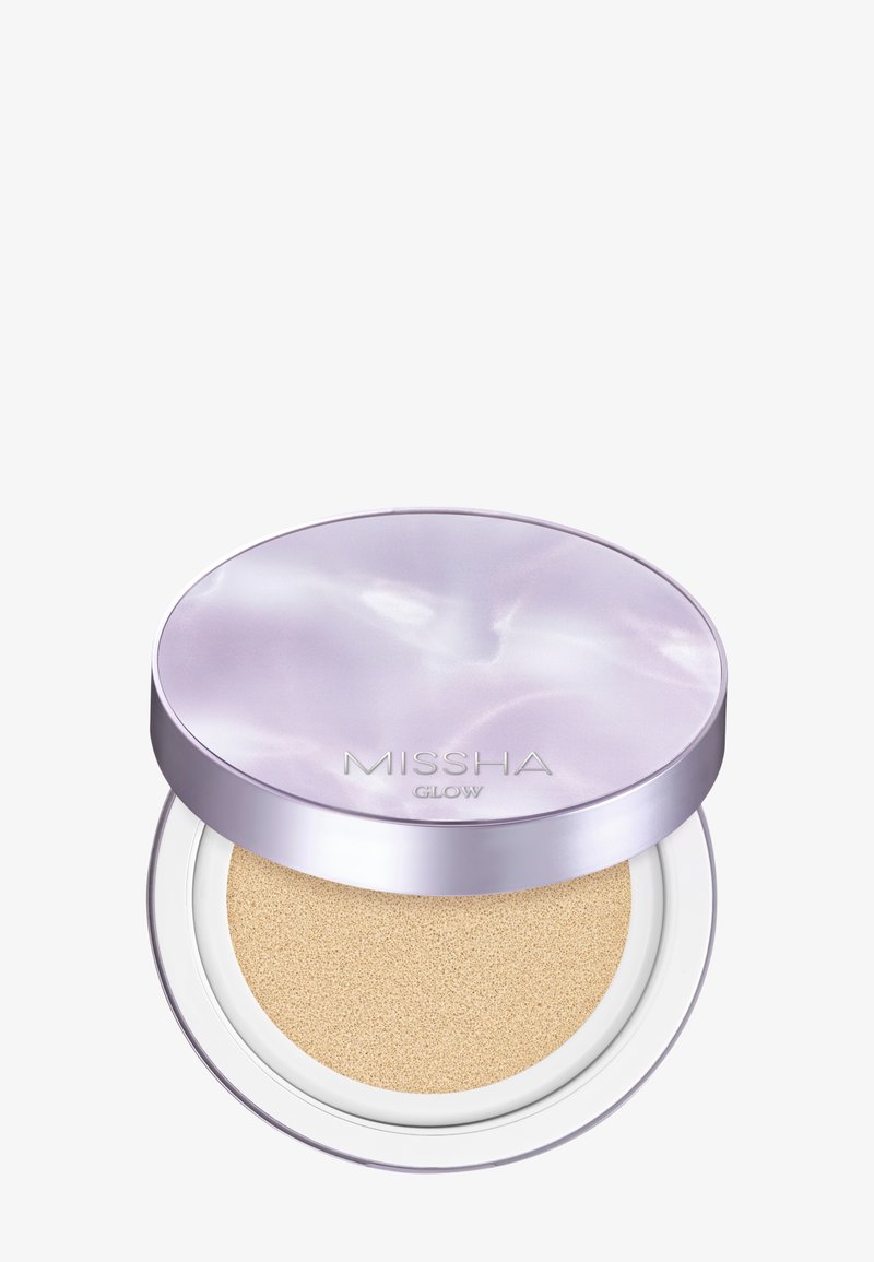 Compact cushion foundation with beige sponge applicator and glossy lavender lid labeled "MISSHA GLOW" against white background.