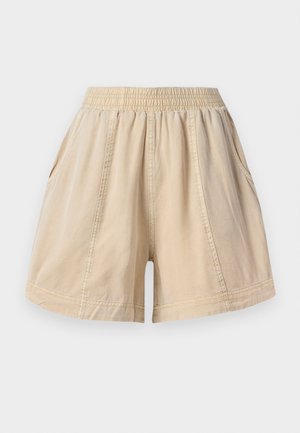 Beige elasztikus derékú shorts oldalsó zsebekkel és látható varrásokkal, könnyű anyagból.