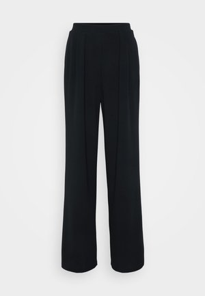 Black wide-leg trousers with a smooth texture, featuring front pleats and an elastic waistband. No pockets or visible hardware.