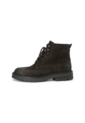 Dark brown suede ankle boots with a round toe, lace-up front, and textured detailing along the seams. Thick black rubber sole.