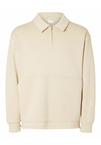 Beige långärmad tröja med krage och en kort dragkedja fram, med en avslappnad passform och minimala design detaljer.