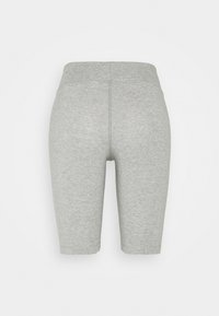 Shorts de vélo gris extensibles avec une taille élastique. Le tissu a une texture lisse, présentant un design simple et minimal.