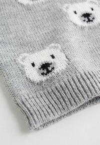 Gray knitted fabric featuring a repeated pattern of white polar bear faces, with black detailing on the snouts and mouths. Ribbed cuff edge.