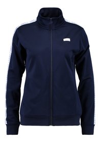 Námořnicky modrá bunda na zip z hladké tkaniny, s vysokým límcem, bočními kapsami a bílými vzorovanými prvky na rukávech.