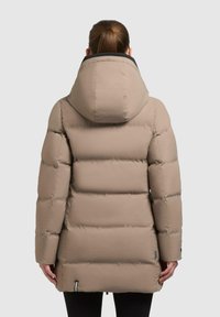 Beige padded jacket with a hood, featuring a quilted design, smooth texture, and visible stitching. Includes a zip fastening and side pockets.