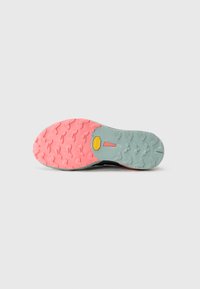 Trail running shoe sole featuring a robust black upper, with a light blue midsole and a pink traction outsole, characterized by aggressive lugs.