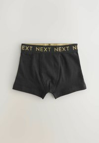 Crne pamučne bokserice s zlatnom elastikom na struku koja prikazuje ponovljenu riječ "NEXT". Imaju glatku teksturu i prilagođen dizajn.