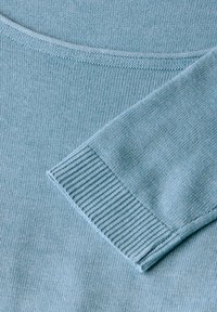 Helles blaues Pullover mit einer glatten Stricktextur, gerippten Ärmelbündchen und Rundhalsausschnitt. Keine zusätzlichen Muster oder Verzierungen.