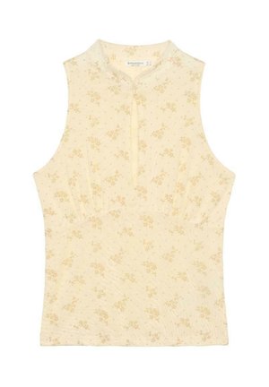 Haut beige sans manches avec un petit motif floral jaune, col montant et une courte fermeture éclair devant au centre.