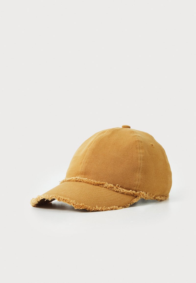 Baseball cap in mustard yellow fabric with frayed edges, curved brim, and stitched top button. Simple design with textured finish.