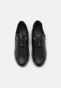 Black leather sneakers with a textured finish, gold accents, and a side zipper. Features round toe and lace-up design. Lightweight construction.