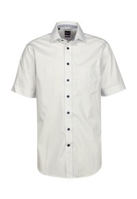 Camicia bianca a maniche corte con pois blu navy, colletto button-down e bottoni blu navy. Presenta una tasca sul lato sinistro.