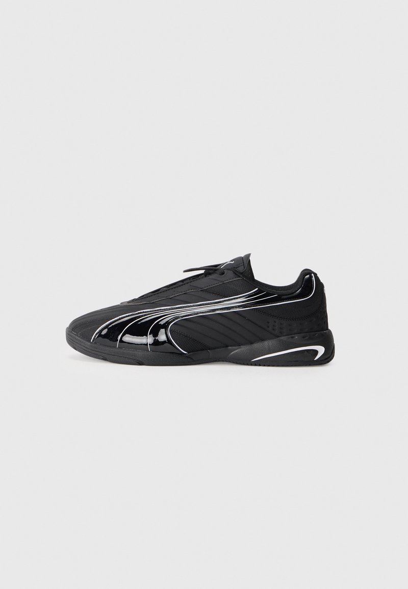 Black athletic shoes with a sleek design, featuring a glossy finish, textured fabric panels, white accent lines, and a low-profile silhouette.