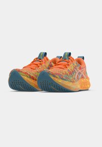 Brightly colored running shoes featuring an orange upper with multicolored patterns, blue accents, and a textured sole with ventilation holes.
