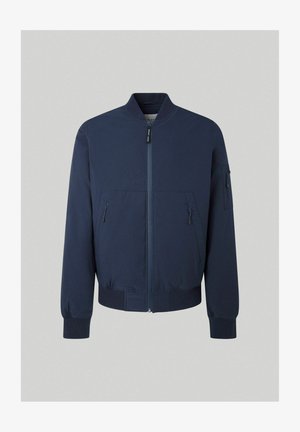 Tmavě modrá bombarďácká bunda s předním zipem, žebrovanými manžetami a dvěma postranními kapsami. Obsahuje také další kapsu na zip na rukávu.