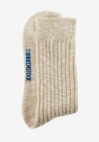 Calzino lavorato a maglia beige con una texture a coste, caratterizzato da un logo blu "Birkenstock". Materiale morbido con un aspetto accogliente.
